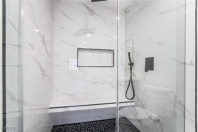 full bath with a marble finish shower