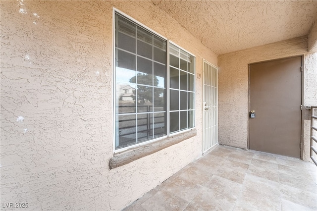 entrance to property with stucco siding