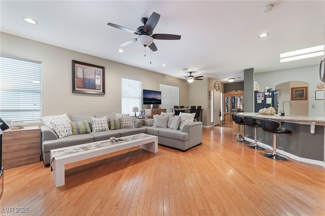 living area with a wealth of natural light, recessed lighting, and light wood-style flooring