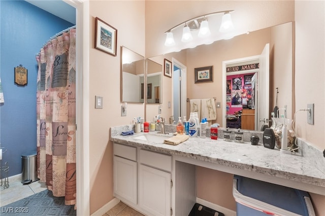 full bathroom with curtained shower, baseboards, vanity, and tile patterned flooring