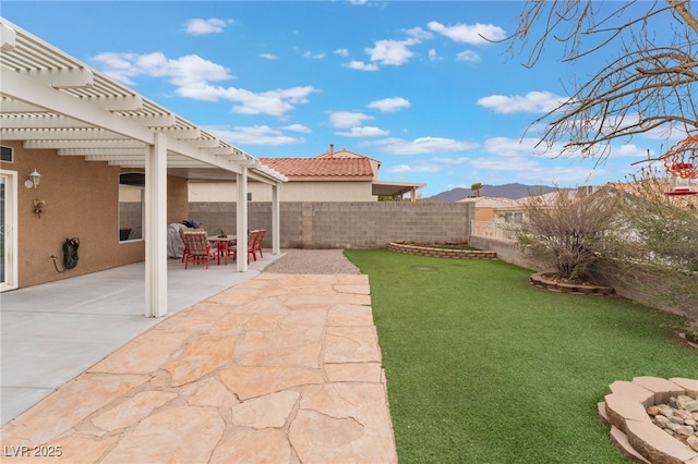 view of yard with a patio, a mountain view, a fenced backyard, and a pergola