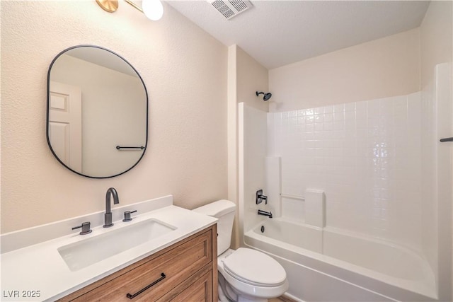 full bathroom with visible vents, tub / shower combination, toilet, and vanity