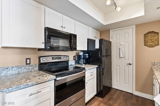 kitchen featuring dark wood-style flooring, black appliances, track lighting, white cabinetry, and a raised ceiling