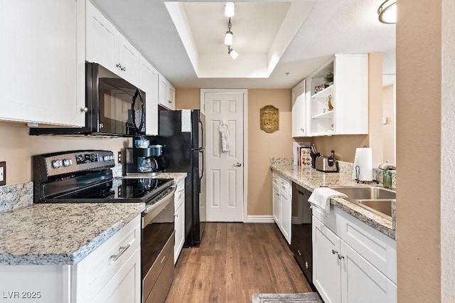 kitchen with open shelves, stainless steel electric range, black microwave, dishwashing machine, and a raised ceiling