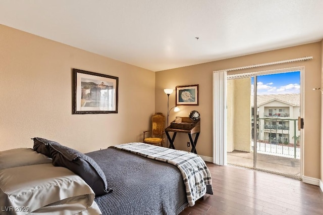 bedroom featuring access to exterior, dark wood finished floors, and baseboards