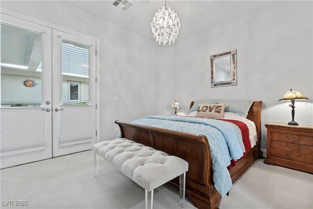 bedroom with a chandelier, visible vents, light carpet, and french doors