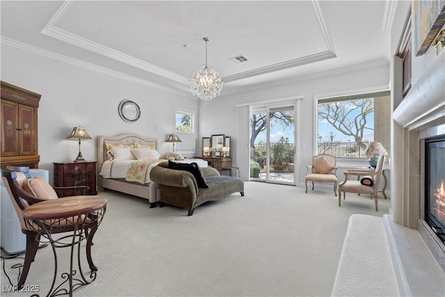 bedroom with visible vents, a glass covered fireplace, access to outside, light colored carpet, and a chandelier