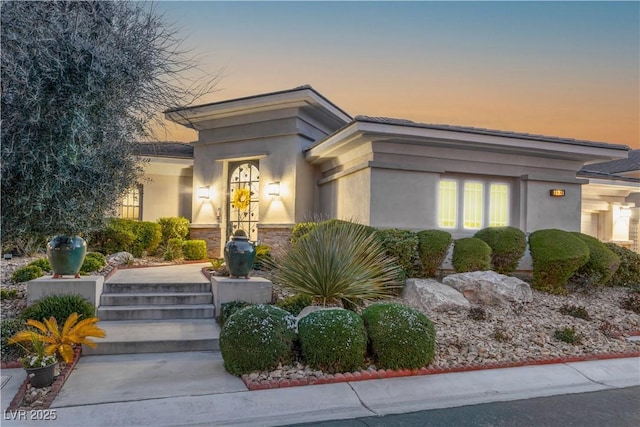 view of front of house featuring stucco siding