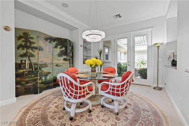 dining room with baseboards, visible vents, carpet floors, and ornamental molding