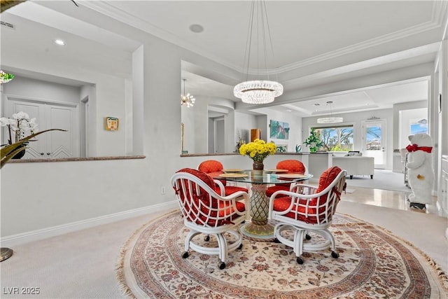 dining space featuring light carpet, a chandelier, baseboards, and ornamental molding