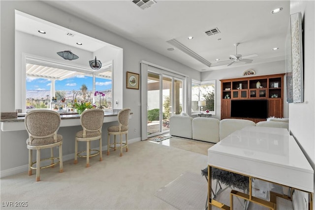 interior space with a raised ceiling, recessed lighting, carpet, and visible vents