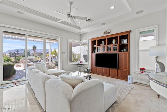 living room featuring visible vents, a tray ceiling, recessed lighting, ceiling fan, and crown molding