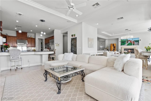 living area with a ceiling fan, crown molding, visible vents, and recessed lighting