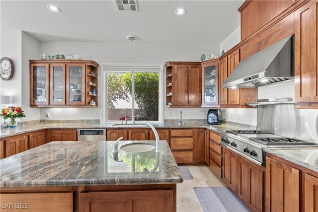 kitchen with brown cabinetry, a sink, wall chimney range hood, and open shelves