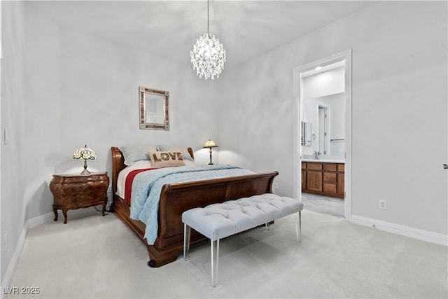 bedroom with baseboards, light carpet, a notable chandelier, and ensuite bath