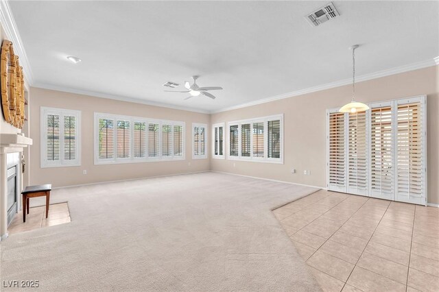 1596 Fieldbrook St, Henderson, NV 89052 - unfurnished living room with ceiling fan, crown molding, baseboards, a glass covered fireplace, and light colored carpet