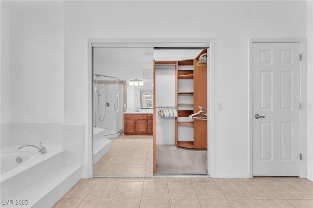 1596 Fieldbrook St, Henderson, NV 89052 - full bath featuring a shower stall, tile patterned flooring, vanity, and a garden tub