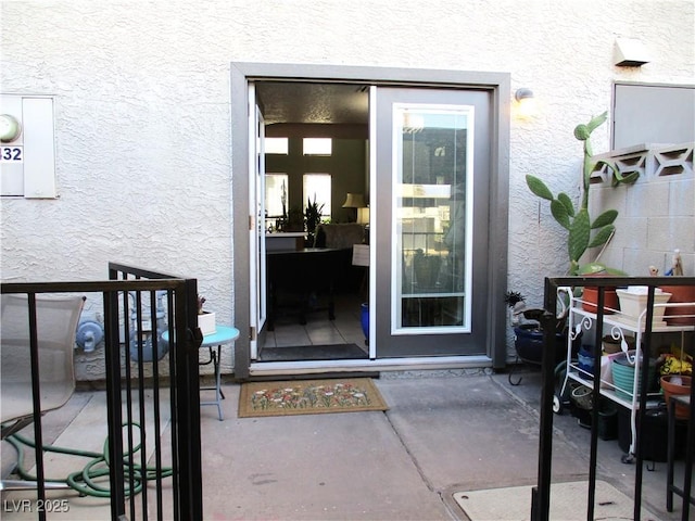 entrance to property with stucco siding