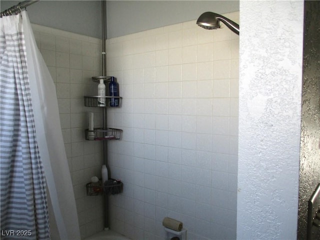 full bath featuring a tile shower