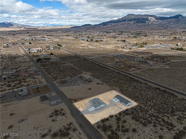 birds eye view of property featuring a mountain view and a desert view