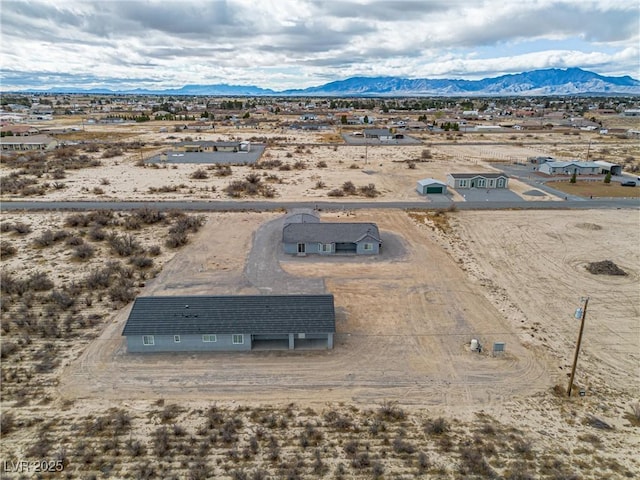 drone / aerial view with view of desert and a mountain view