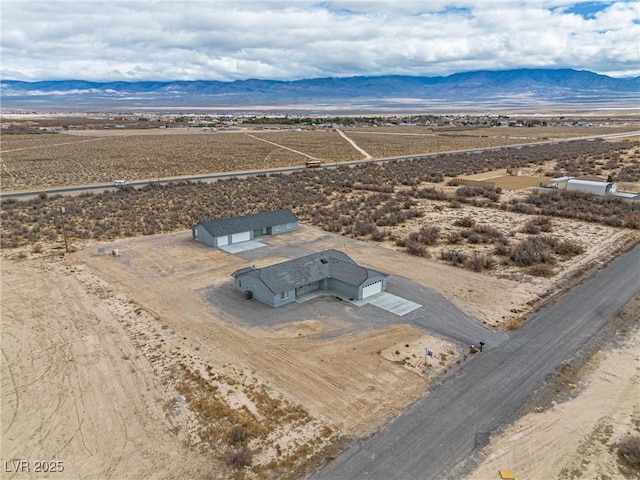 birds eye view of property featuring a desert view and a mountain view