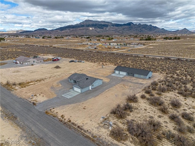 drone / aerial view with a mountain view, a rural view, and view of desert