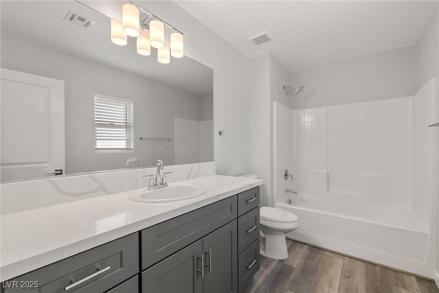 full bath with visible vents, toilet, vanity, and wood finished floors