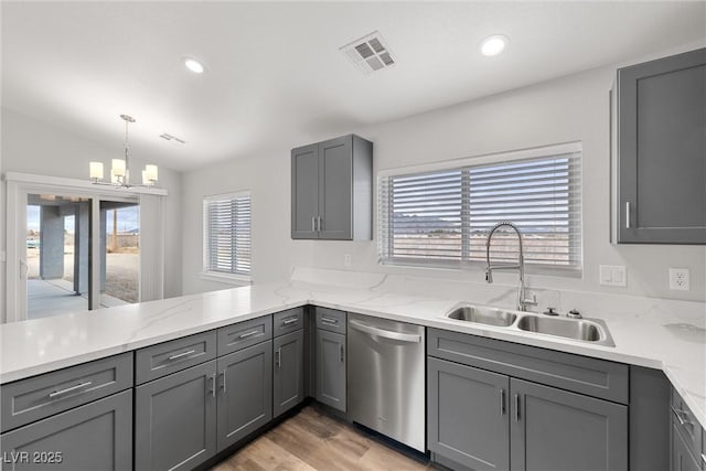 kitchen featuring a sink, dishwasher, and gray cabinets