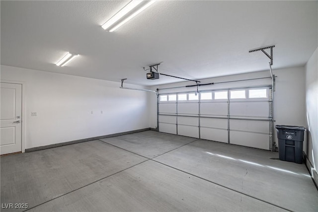 garage featuring baseboards and a garage door opener