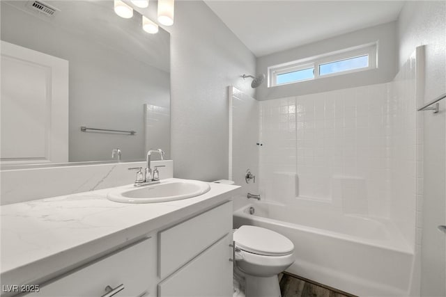 full bath with visible vents, toilet, wood finished floors, shower / bathing tub combination, and vanity