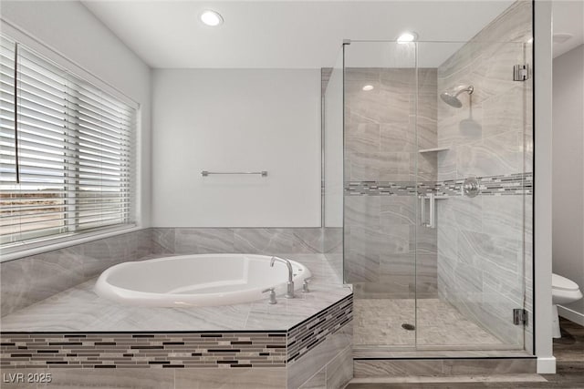 bathroom featuring a garden tub, toilet, and a stall shower