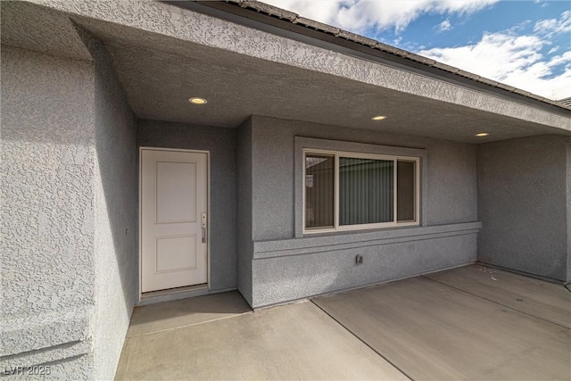 doorway to property with stucco siding