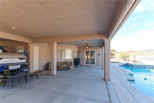 view of patio featuring an outdoor pool and ceiling fan