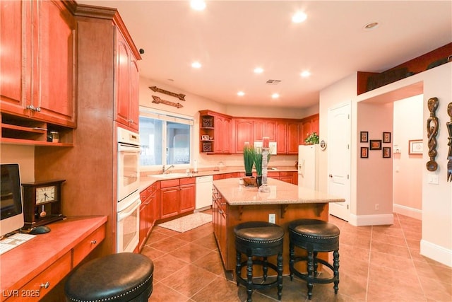 kitchen with open shelves, a kitchen island, recessed lighting, white appliances, and a sink