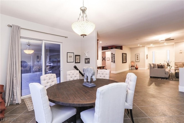 dining room featuring baseboards and dark tile patterned flooring