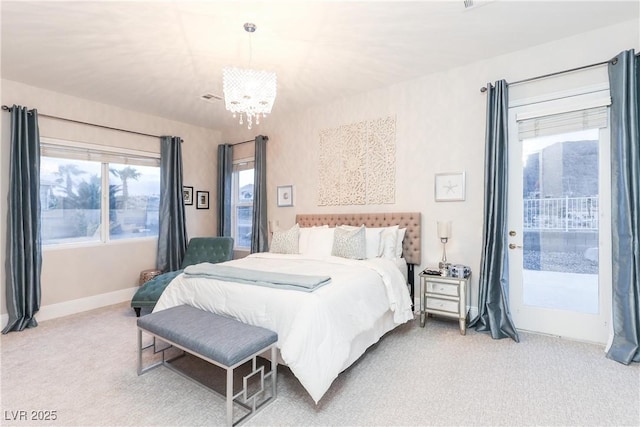 carpeted bedroom featuring a chandelier, baseboards, and access to exterior