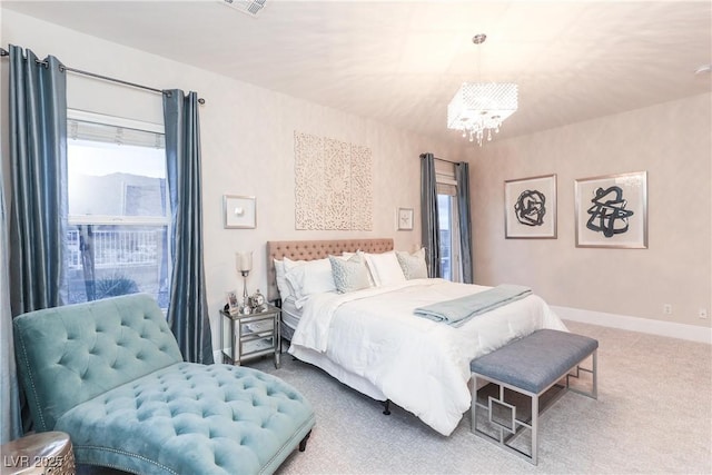 bedroom featuring baseboards, an inviting chandelier, and carpet floors