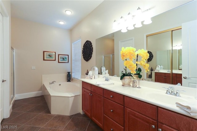 bathroom featuring tile patterned floors, a garden tub, a sink, a shower stall, and double vanity