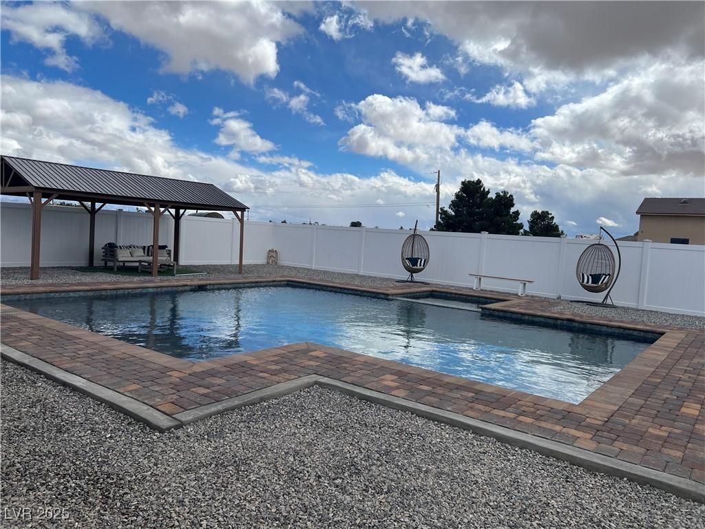 view of swimming pool with a patio area, a fenced in pool, a gazebo, and a fenced backyard