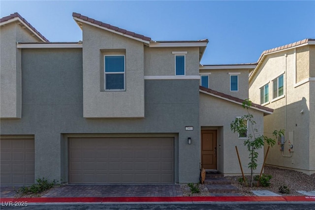 2901 Bahama Yellow Ave, North Las Vegas, NV 89086 - view of front of house featuring a tiled roof, a garage, and stucco siding