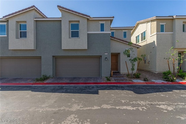 2901 Bahama Yellow Ave, North Las Vegas, NV 89086 - townhome / multi-family property with a tiled roof, driveway, a garage, and stucco siding