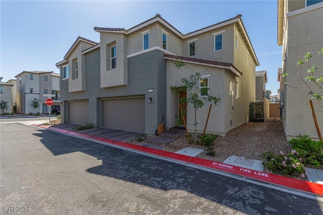 2901 Bahama Yellow Ave, North Las Vegas, NV 89086 - exterior space with a residential view, stucco siding, a tile roof, a garage, and a gate