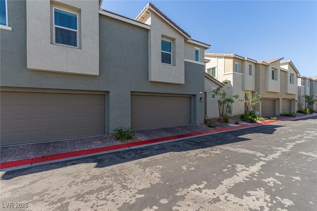 2901 Bahama Yellow Ave, North Las Vegas, NV 89086 - view of front of house featuring a garage, a residential view, and stucco siding