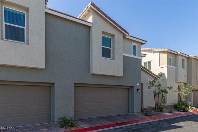 2901 Bahama Yellow Ave, North Las Vegas, NV 89086 - view of property featuring stucco siding, an attached garage, and a tile roof