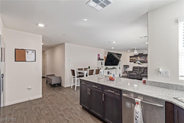 2901 Bahama Yellow Ave, North Las Vegas, NV 89086 - kitchen with open floor plan, light stone counters, dishwasher, and visible vents