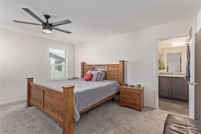 2901 Bahama Yellow Ave, North Las Vegas, NV 89086 - bedroom featuring light carpet, ensuite bath, baseboards, and a sink