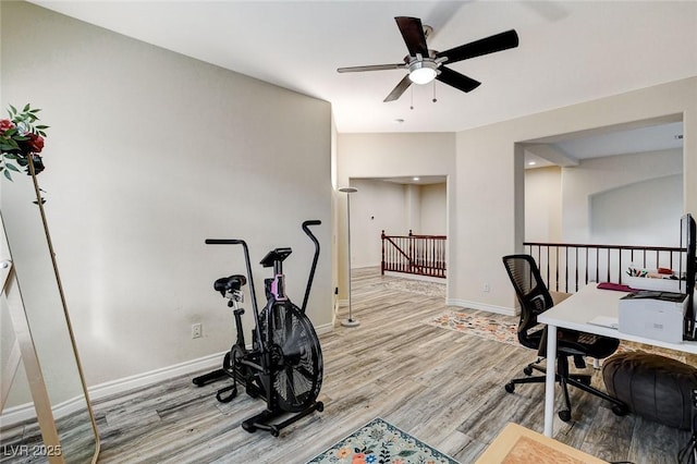 office area with ceiling fan, baseboards, and wood finished floors