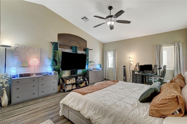 bedroom featuring visible vents, multiple windows, wood finished floors, and vaulted ceiling