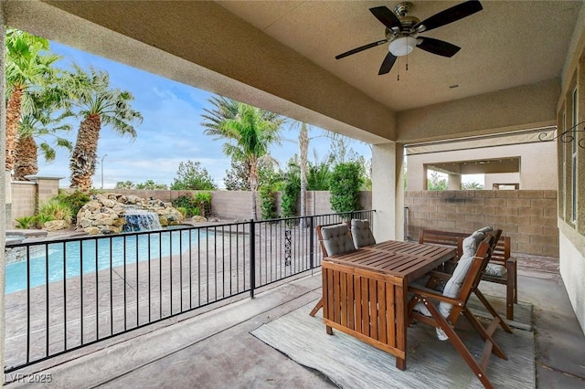 view of patio / terrace featuring a fenced backyard, outdoor dining space, a fenced in pool, and ceiling fan